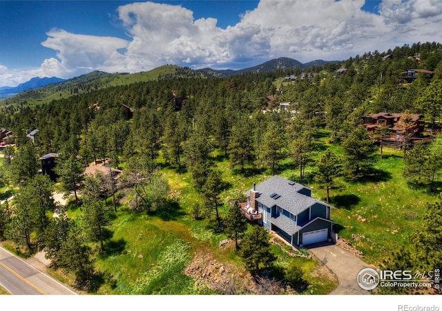 aerial view with a mountain view and a view of trees