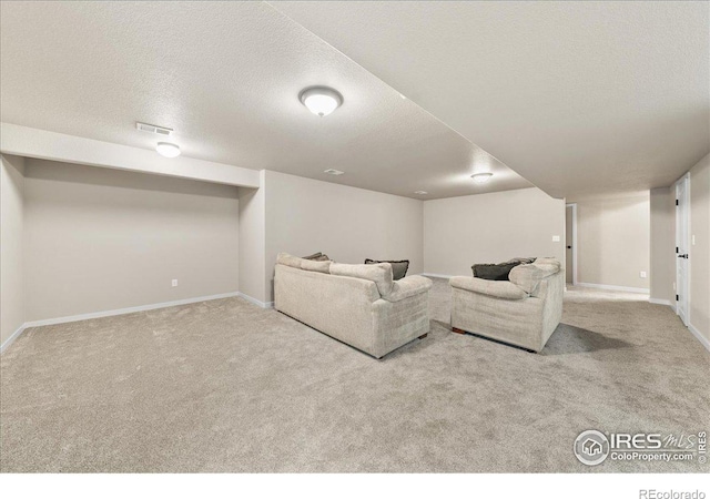 carpeted living room with baseboards, visible vents, and a textured ceiling