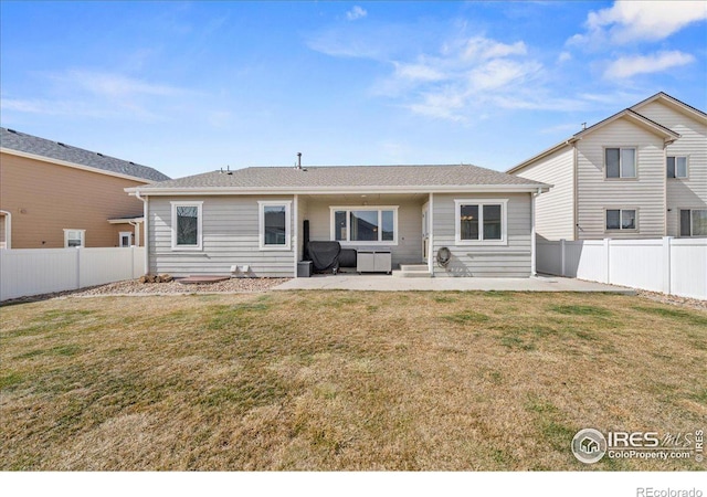 back of property with a patio area, a fenced backyard, and a yard