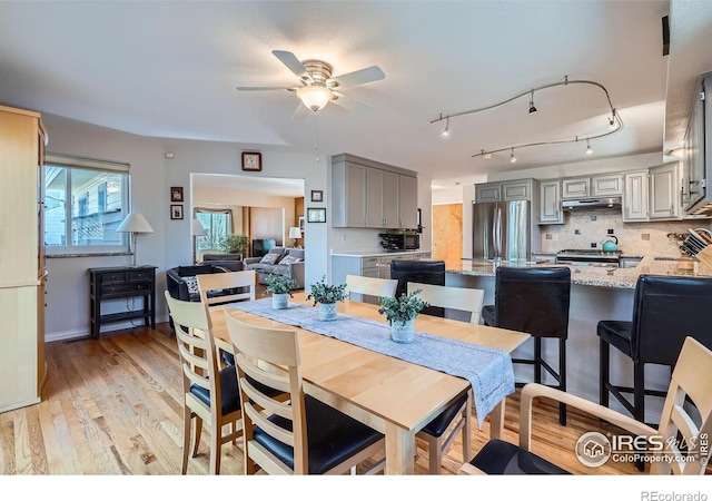 dining area featuring light wood-style flooring and ceiling fan