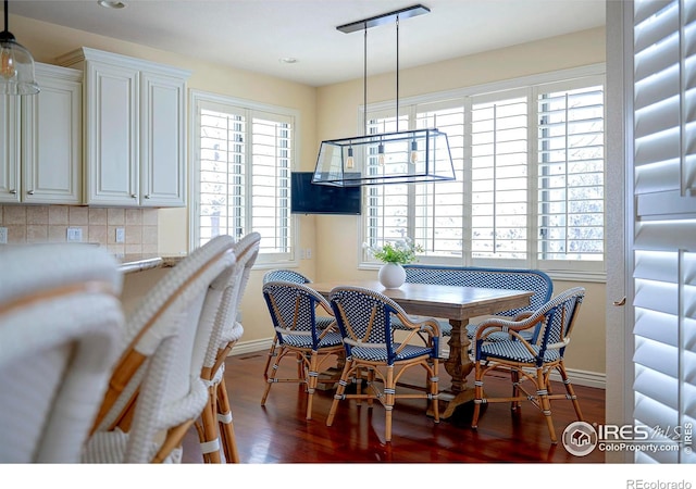 dining space with baseboards, dark wood finished floors, and recessed lighting