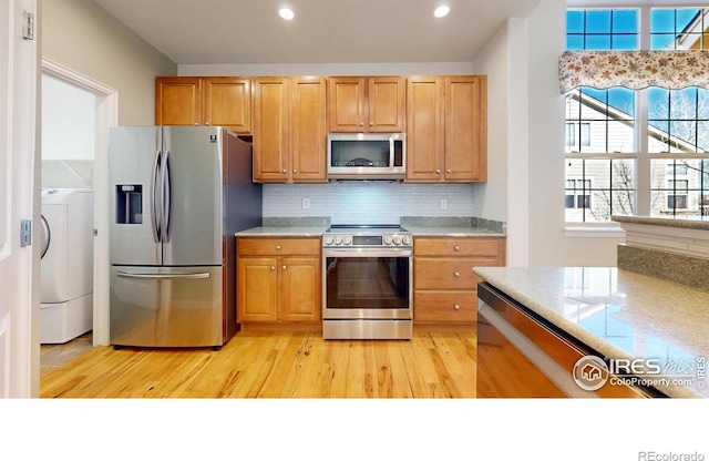 kitchen featuring recessed lighting, washer / clothes dryer, decorative backsplash, appliances with stainless steel finishes, and light wood-style floors