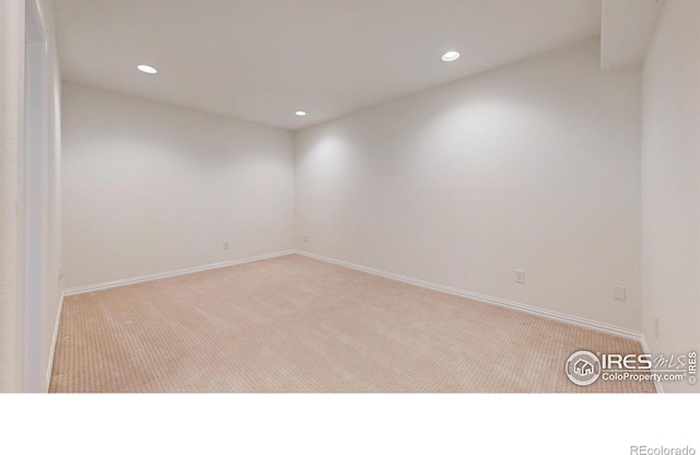 carpeted empty room with recessed lighting and baseboards