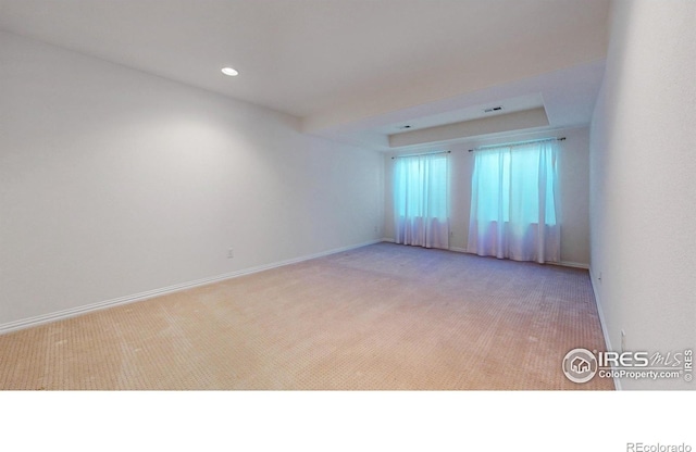 spare room with carpet, visible vents, baseboards, and recessed lighting