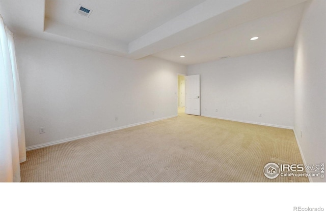 carpeted empty room with baseboards, visible vents, and recessed lighting