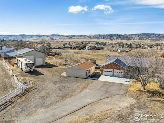 birds eye view of property featuring a mountain view and a rural view