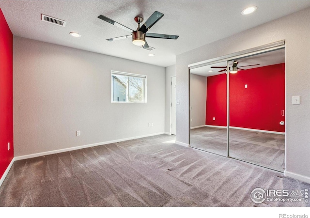 unfurnished bedroom with carpet, visible vents, a closet, and baseboards