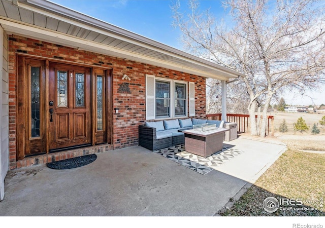 entrance to property with brick siding and an outdoor hangout area