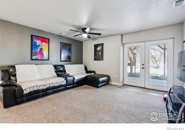 living area featuring visible vents, carpet flooring, french doors, and a textured ceiling