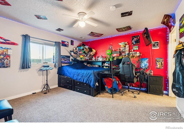 carpeted bedroom with baseboards, a textured ceiling, and a ceiling fan