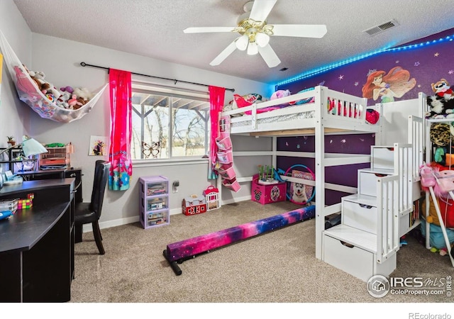 bedroom with visible vents, ceiling fan, carpet, baseboards, and a textured ceiling