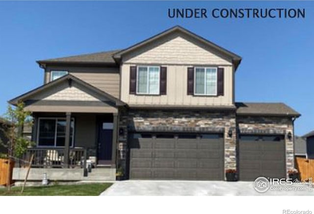 view of front of house featuring a porch, concrete driveway, and a garage