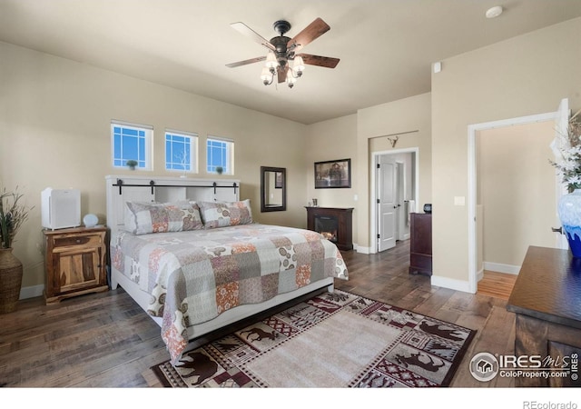 bedroom with wood-type flooring, baseboards, and ceiling fan