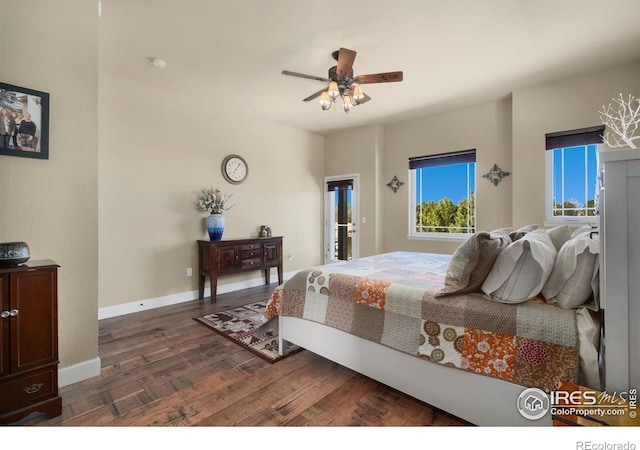 bedroom with ceiling fan, dark wood-type flooring, and baseboards