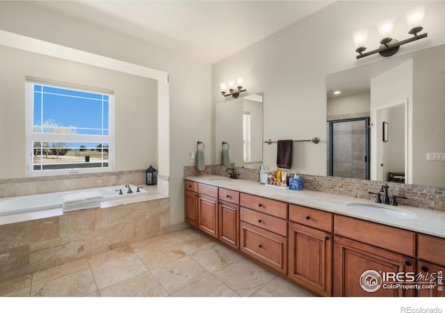 bathroom featuring double vanity, a sink, a shower stall, and a bath