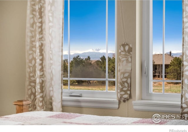 unfurnished bedroom featuring a mountain view