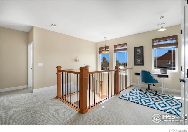 carpeted home office with visible vents and baseboards