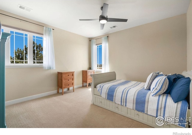 carpeted bedroom featuring visible vents, ceiling fan, and baseboards