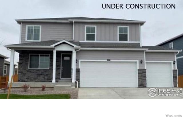 1854 Westport Ave, Berthoud, CO 80513 - view of front of house featuring board and batten siding, concrete driveway, and an attached garage