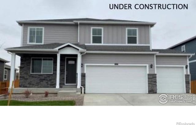 view of front of house featuring board and batten siding, concrete driveway, and an attached garage