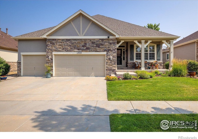 craftsman-style home with stucco siding, covered porch, concrete driveway, a front yard, and a garage