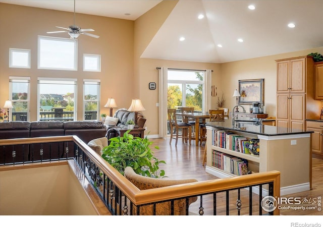 interior space with recessed lighting, light wood-style flooring, and high vaulted ceiling