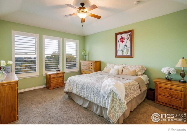 bedroom with baseboards, a ceiling fan, lofted ceiling, and carpet flooring