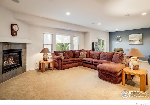 living area featuring recessed lighting, baseboards, carpet floors, and a tiled fireplace