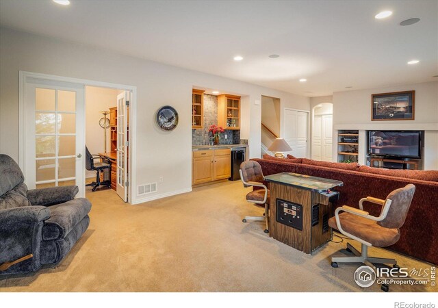 living area featuring visible vents, light carpet, recessed lighting, stairway, and a bar