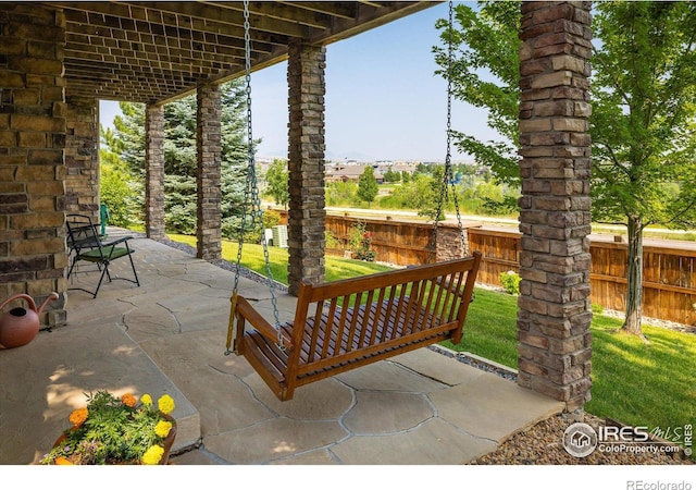 view of patio featuring fence