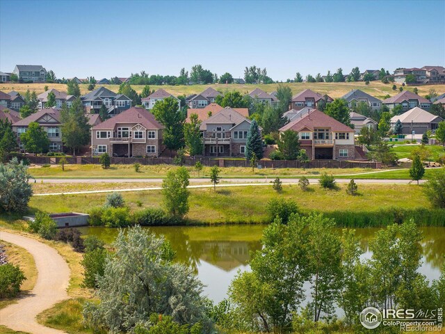 birds eye view of property featuring a residential view and a water view