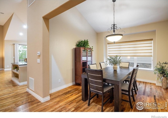 13943 W 87th Ln, Arvada, CO 80005 - dining space featuring light wood-style floors, vaulted ceiling, and baseboards