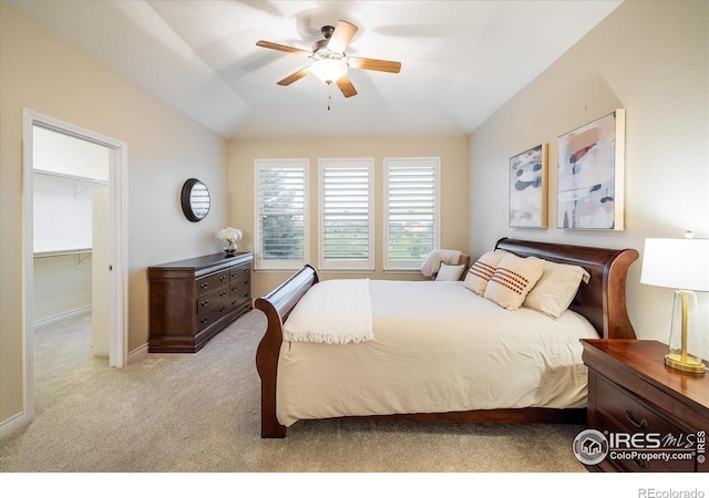 13943 W 87th Ln, Arvada, CO 80005 - bedroom featuring light colored carpet, a walk in closet, a ceiling fan, a closet, and vaulted ceiling