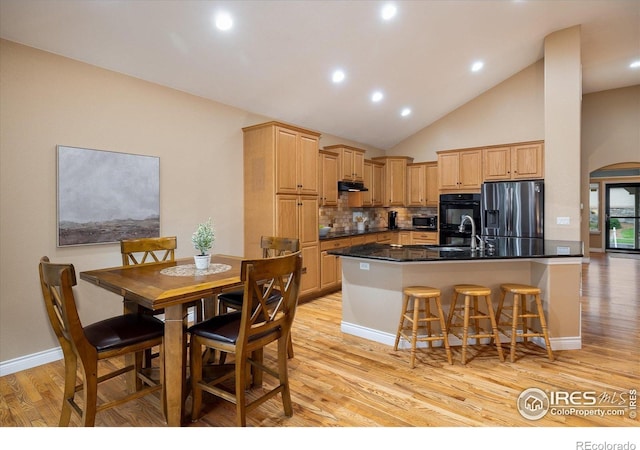 13943 W 87th Ln, Arvada, CO 80005 - kitchen with black appliances, a sink, light wood finished floors, tasteful backsplash, and recessed lighting