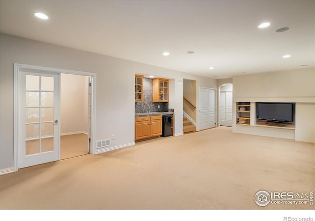 13943 W 87th Ln, Arvada, CO 80005 - unfurnished living room featuring light carpet, bar, baseboards, recessed lighting, and stairway