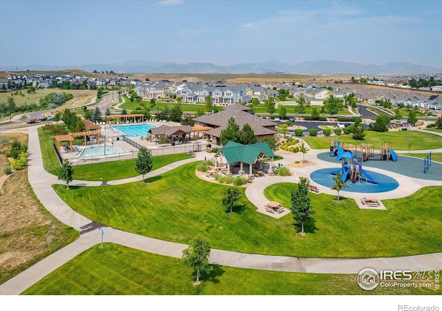 13943 W 87th Ln, Arvada, CO 80005 - aerial perspective of suburban area featuring a community park, a pool area, and a mountainous background