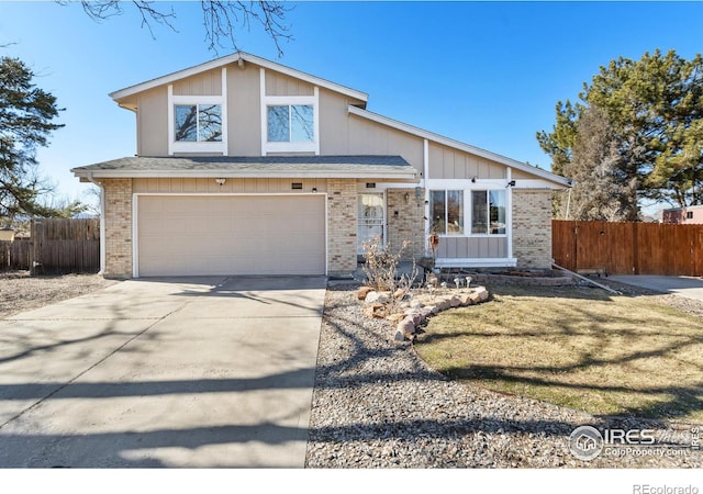 view of front of property with driveway, a garage, fence, and brick siding