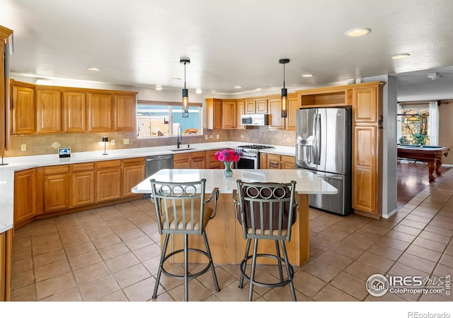 kitchen featuring light tile patterned floors, stainless steel appliances, a sink, and light countertops