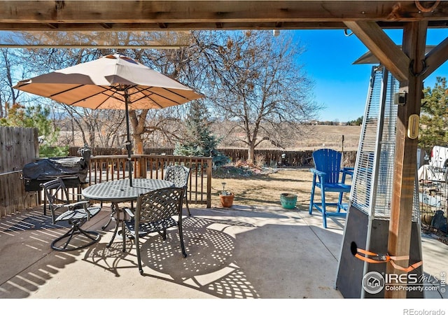 view of patio with outdoor dining area, grilling area, and a fenced backyard