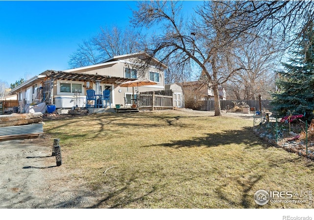 view of front of property featuring fence, an outdoor structure, a shed, a front lawn, and a pergola