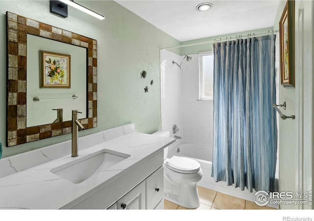 full bath featuring a textured wall, toilet, shower / tub combo with curtain, tile patterned floors, and vanity