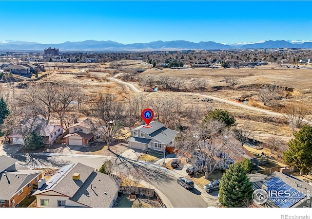 drone / aerial view featuring a residential view and a mountain view