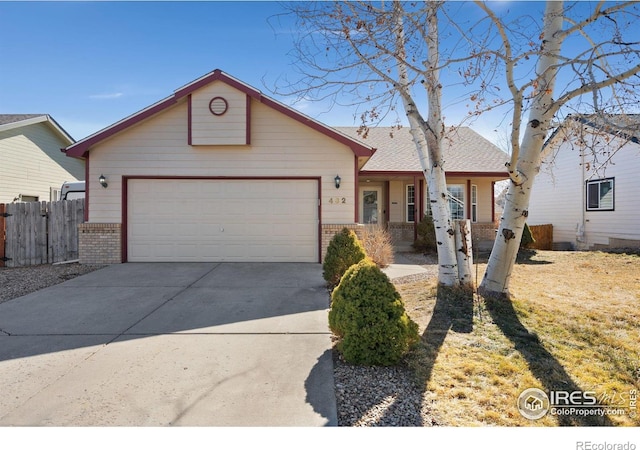 ranch-style house with driveway, a garage, fence, and brick siding