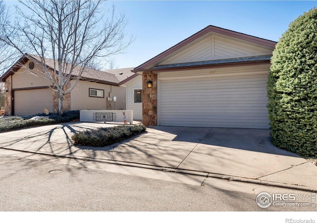 single story home featuring a garage and concrete driveway