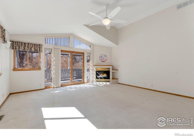 unfurnished living room with lofted ceiling, carpet floors, a fireplace, visible vents, and baseboards