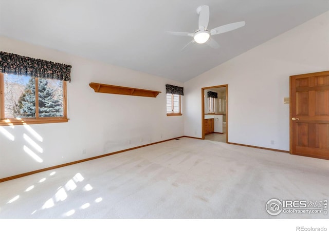 unfurnished bedroom featuring carpet floors, baseboards, vaulted ceiling, and connected bathroom