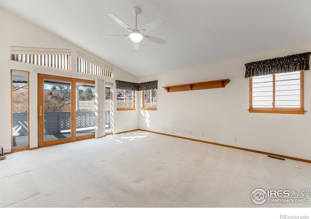 unfurnished room featuring carpet floors, plenty of natural light, visible vents, and ceiling fan