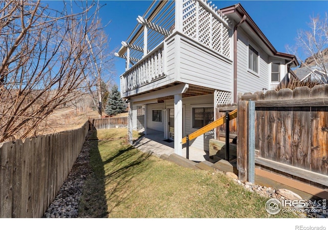 view of home's exterior featuring a patio, a yard, and a fenced backyard