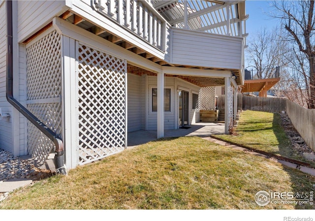 exterior space with a fenced backyard, a patio, and a balcony