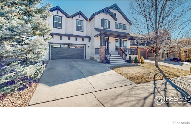 view of front of home with an attached garage, covered porch, board and batten siding, and concrete driveway